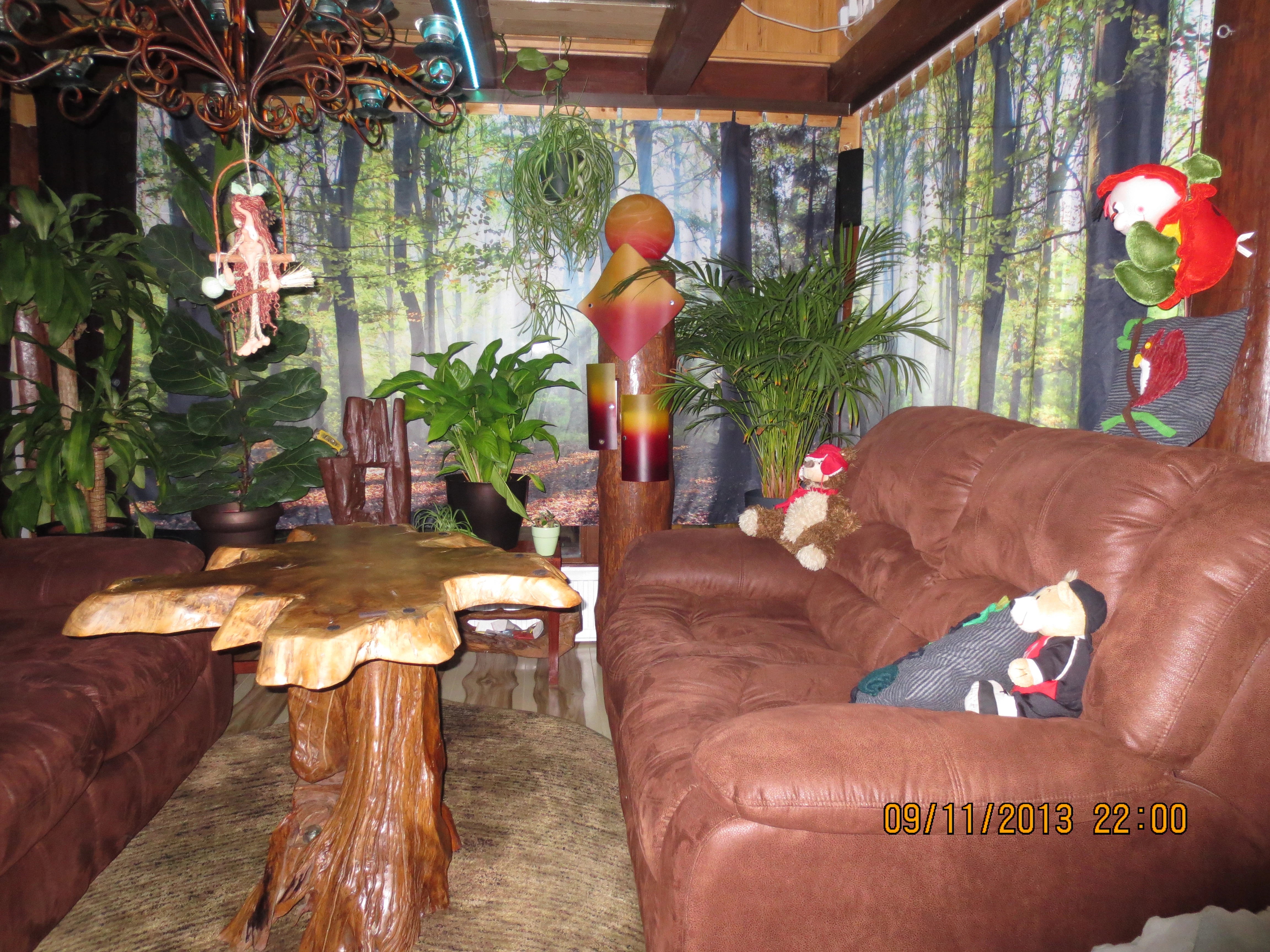 mit Waldmotiven bedruckte Gardinen im passend eingerichteten Wohnzimmer 