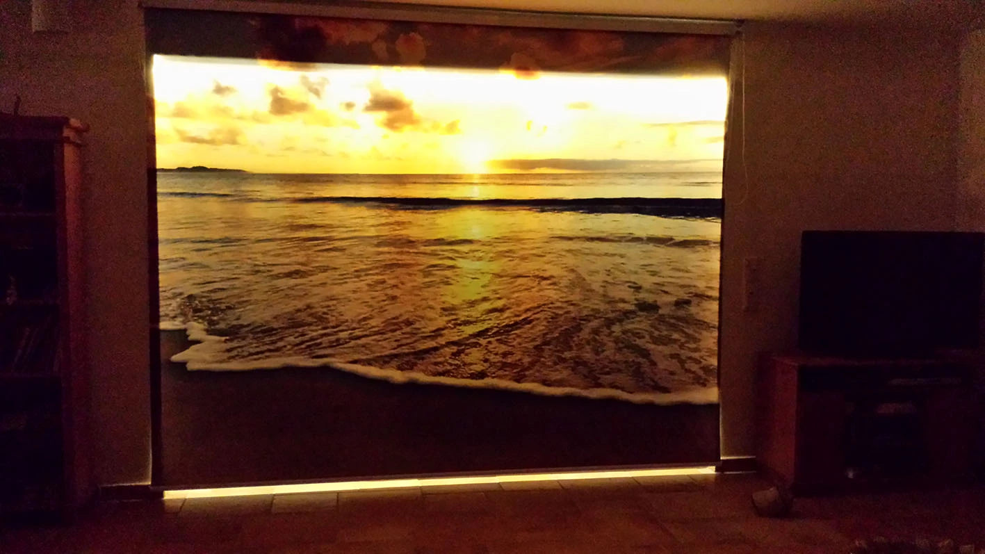 Fotorollo mit Foto bedruckt Motiv vom Sonnenuntergang am Meer wird beleuchtet und die Farben strahlen intensiv